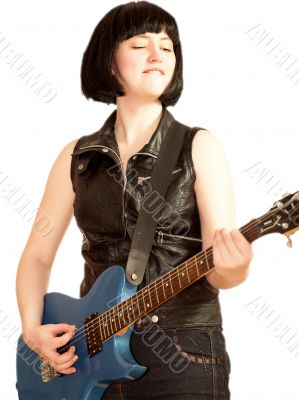 Young woman plays on a electric guitar