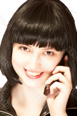 Young beautiful brunette talking to mobile phone Young beautiful brunette talking to mobile phone