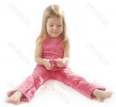 pretty small girl is cutting paper heart shape pretty small girl is cutting paper heart shape