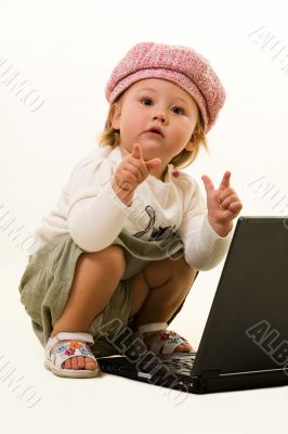 Adorable baby with laptop