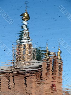 Church Cupola reflected in wavy water