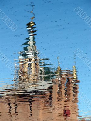 Church Cupola reflected in wavy water