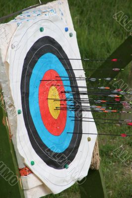 archery arrows aimed into colorful target