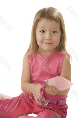 pretty small girl is cutting paper heart shape pretty small girl is cutting paper heart shape