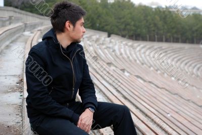 cool man sitting alone in stadium tribun cool man sitting alone in stadium tribun