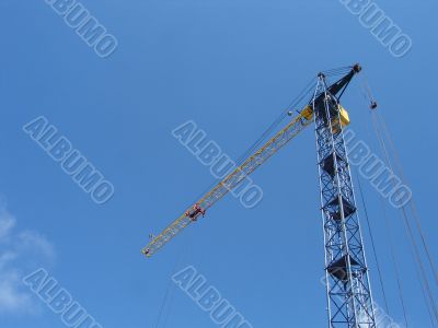 Lifting construction crane at blue sky