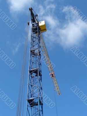 Lifting construction crane at blue sky