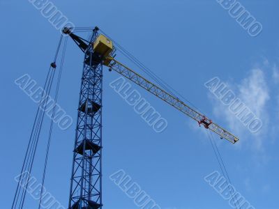 Lifting construction crane at blue sky