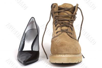 Black Women`s High-Heel Shoe beside men`s workboot