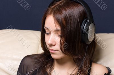 The young girl listens to music