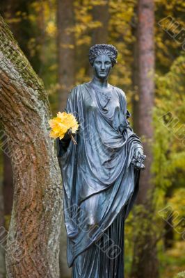 Statue of the woman with autumn leaves