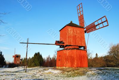 Two Red Wooden Windmills