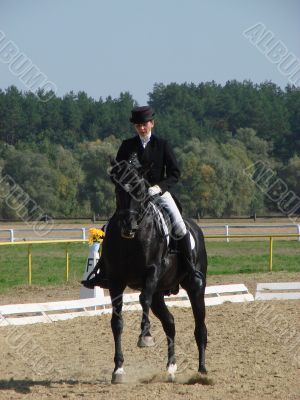 equestrian woman on black stallion horse