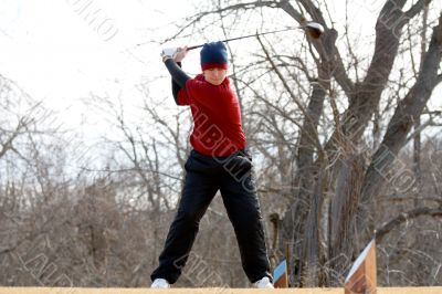Youth golfer hitting a tee shot