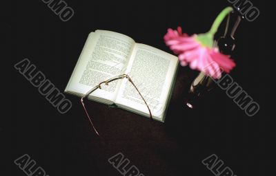 Open book and glasse on black Open book and glasse on black