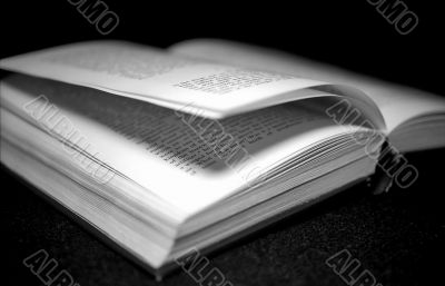 Open book on black monochrome