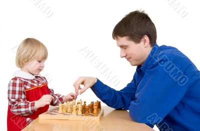 Man and girl play chess