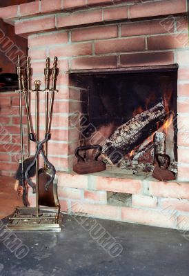 Fireplace with two old irons in it