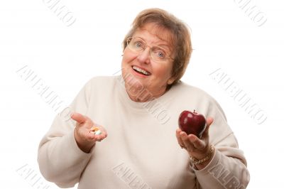 Confused Senior Woman Holding Apple and Vitamins