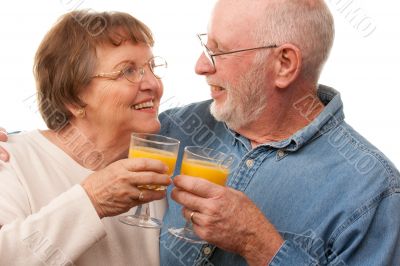 Happy Senior Couple with Glasses of Orange Juice