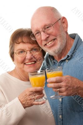 Happy Senior Couple with Glasses of Orange Juice