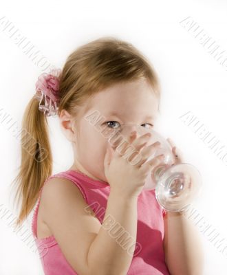 Small girl is drinking the water