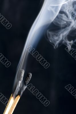 match with smoke on black background