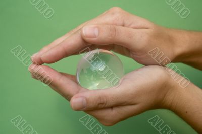 Hands with glass globe