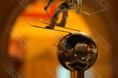 Skier statue over silver ball
