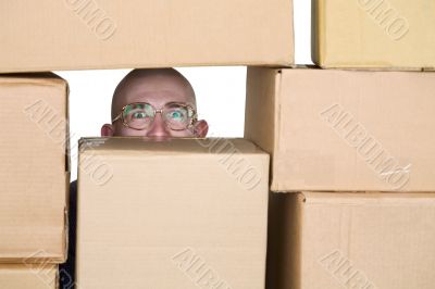 Man looking through pile of cardboard boxes