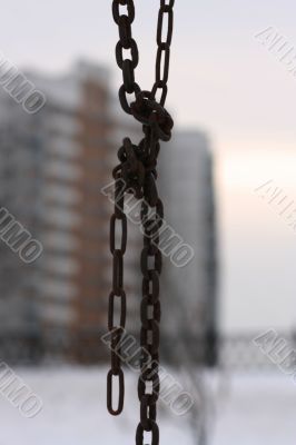 A sight to the city through a chain