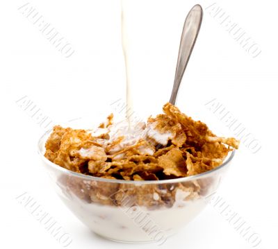 milk pouring onto cornflakes