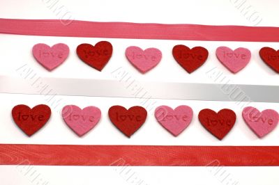 A lot of red and pink hearts with colours ribbons