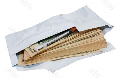 Dollars and syringe in open envelope