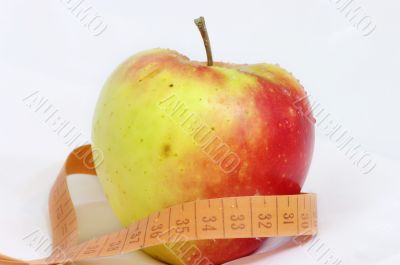 apple and measuring tape isolated on white background
