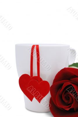 A cup with two red hearts and flower