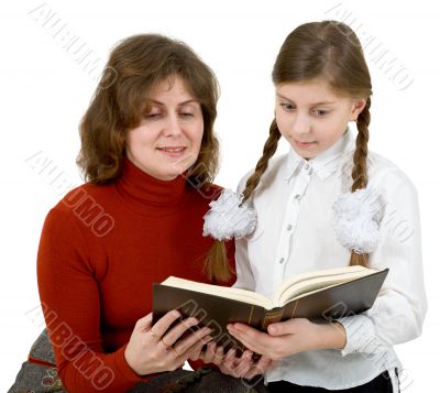 Woman and girl reading book