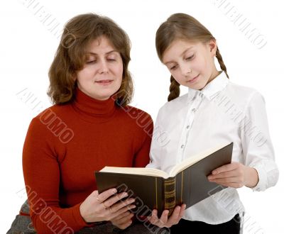 Woman and girl reading book
