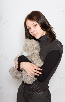  girl holding a teddy bear in her arms