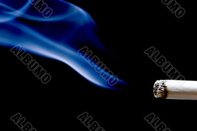 cigarette with smoke on black background