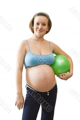 Young pregnant woman with green ball