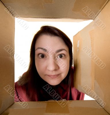 Female portrait through  cardboard box