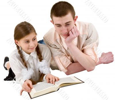 Girl and young man reading book in a reclining position