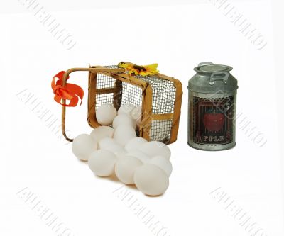 Wire basket of eggs and milk tin