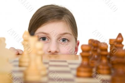 Girl looking chess