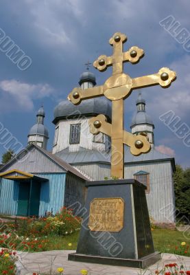 Huge golden christian cross near church