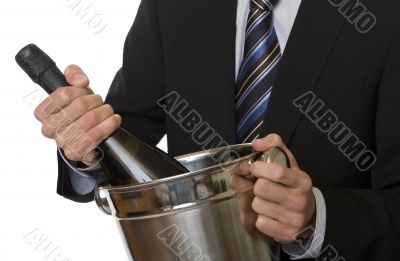 Man with suit champagne bottle in ice-pail