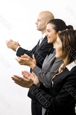 Businesspeople in a row clapping