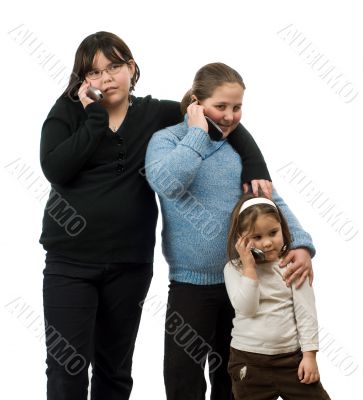 Three Girls Talking On Cell Phones