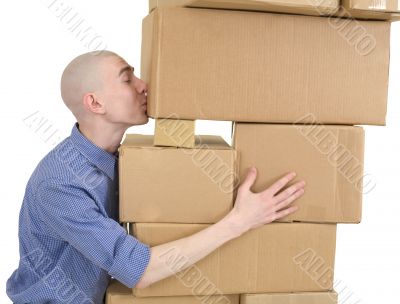 Man kisses heap cardboard boxes